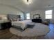 Stylish main bedroom with large bed, big windows, and round rug at 28 Samuel Nw Way, Cartersville, GA 30121