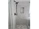 Shower features gray subway tile, pebble stone floor, and a recessed niche for shower supplies at 28 Samuel Nw Way, Cartersville, GA 30121
