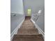 Staircase featuring wood stairs, white railings, and a window providing natural light to the upper level at 28 Samuel Nw Way, Cartersville, GA 30121