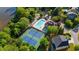 Aerial view of tennis courts, pool, clubhouse, and playground in a community bordering a lake at 4830 Frontier Dr, Cumming, GA 30028