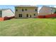Large, grassy backyard with a partial wooden fence offering space for outdoor activities at 4830 Frontier Dr, Cumming, GA 30028