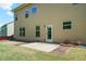 Back of home with vinyl siding, walk-out access to backyard, and a small patio area for entertaining at 4830 Frontier Dr, Cumming, GA 30028