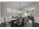 Dining room features wainscoting, modern light fixture, and a dining table with seating for six at 4830 Frontier Dr, Cumming, GA 30028