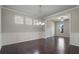 Elegant dining room with hardwood floors, wainscoting, and a chandelier at 4830 Frontier Dr, Cumming, GA 30028