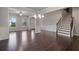 Open concept dining room featuring hardwood floors, wainscotting and views to the front yard at 4830 Frontier Dr, Cumming, GA 30028