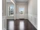 Bright entryway featuring hardwood floors, white trim, and a glass-paneled front door at 4830 Frontier Dr, Cumming, GA 30028