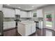 Well-equipped kitchen with granite countertops, island, stainless appliances, and backyard access at 4830 Frontier Dr, Cumming, GA 30028