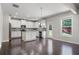 Modern kitchen with white cabinets, stainless steel appliances, and hardwood floors at 4830 Frontier Dr, Cumming, GA 30028
