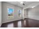 Inviting living room with hardwood floors, large windows, and neutral paint at 4830 Frontier Dr, Cumming, GA 30028