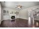 Inviting living room with hardwood floors, fireplace, built-in shelving, and ample natural light at 4830 Frontier Dr, Cumming, GA 30028