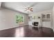 Cozy living room with a fireplace, built-in cabinets, and a ceiling fan at 4830 Frontier Dr, Cumming, GA 30028