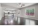 Open concept living room with hardwood floors, large windows, and access to the kitchen at 4830 Frontier Dr, Cumming, GA 30028