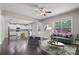 Open concept living room and kitchen with stainless steel appliances and hardwood floors at 4830 Frontier Dr, Cumming, GA 30028