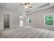 Spacious main bedroom with tray ceiling, carpet floors, and ensuite bathroom access at 4830 Frontier Dr, Cumming, GA 30028