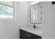 Stylish powder room featuring a decorative mirror and marbled countertop, adding charm and elegance to the space at 90 Cleveland Unit A Se St, Atlanta, GA 30316