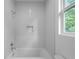 Bathroom showing the tiled tub and shower featuring a modern showerhead and a niche at 90 Cleveland Unit A Se St, Atlanta, GA 30316