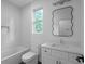 Bathroom featuring a large decorative mirror, contemporary vanity, and neutral color palette at 90 Cleveland Unit A Se St, Atlanta, GA 30316