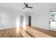 Spacious bedroom with hardwood floors, modern ceiling fan, and ample natural light from multiple windows and a door at 90 Cleveland Unit A Se St, Atlanta, GA 30316