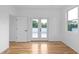 Light-filled bedroom with hardwood floors, double doors, and large windows offering outdoor views at 90 Cleveland Unit A Se St, Atlanta, GA 30316