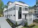 Modern three-story home featuring a white and gray exterior with manicured landscaping at 90 Cleveland Unit A Se St, Atlanta, GA 30316