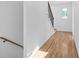 Bright hallway with gleaming hardwood floors and a modern staircase, creating an inviting transition between levels at 90 Cleveland Unit A Se St, Atlanta, GA 30316