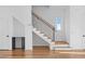 Staircase with wooden steps, black railings, and white walls, exuding modern elegance at 90 Cleveland Unit A Se St, Atlanta, GA 30316