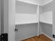 Walk-in closet with built-in shelving and hardwood floors is a haven for organized storage at 90 Cleveland Unit A Se St, Atlanta, GA 30316
