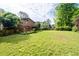 Large backyard with a deck, mature trees and green grass at 140 N Star Sw Trl, Atlanta, GA 30331