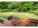 Beautiful backyard featuring mature trees and a deck with outdoor dining at 140 N Star Sw Trl, Atlanta, GA 30331