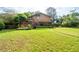 Expansive backyard featuring a wooden deck, patio area, and lush green lawn at 140 N Star Sw Trl, Atlanta, GA 30331