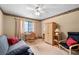 Neutral bedroom featuring a futon, a chair, an armoire and a desk situated in front of a window at 140 N Star Sw Trl, Atlanta, GA 30331