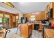 Warm kitchen features oak cabinets, black appliances, and a functional center island with seating at 140 N Star Sw Trl, Atlanta, GA 30331