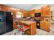 Kitchen with wooden cabinets, tiled backsplash, and eat in bar at 140 N Star Sw Trl, Atlanta, GA 30331