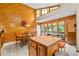 Bright kitchen dining area with wood-paneled walls, tile floors, and a central island at 140 N Star Sw Trl, Atlanta, GA 30331