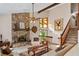 Cozy living room with vaulted ceiling, stone fireplace, and stained glass windows at 140 N Star Sw Trl, Atlanta, GA 30331