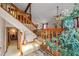 Inviting living room featuring a vaulted ceiling, wooden railing, and large plants at 140 N Star Sw Trl, Atlanta, GA 30331