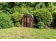 Backyard storage shed surrounded by lush greenery at 140 N Star Sw Trl, Atlanta, GA 30331