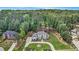 Expansive property featuring a grand home, lush landscaping, and surrounding trees at 2425 Wild Oak Ct, Stockbridge, GA 30281