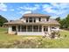 Expansive backyard with a brick exterior, screened-in porch, and outdoor grill area at 2425 Wild Oak Ct, Stockbridge, GA 30281