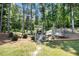 Enjoy a private backyard featuring a pergola and trampoline surrounded by lush trees and greenery at 2425 Wild Oak Ct, Stockbridge, GA 30281