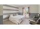 Stylish bedroom with a gray and white striped wall, and French doors to a balcony at 2425 Wild Oak Ct, Stockbridge, GA 30281