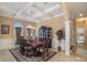 Formal dining room with coffered ceilings, elegant china cabinet, and stylish decor at 2425 Wild Oak Ct, Stockbridge, GA 30281