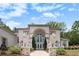 Elegant home showcasing lion statues, a grand entrance, and pristine landscaping at 2425 Wild Oak Ct, Stockbridge, GA 30281