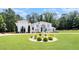Spacious home with manicured lawn, fountain, and lush trees offers curb appeal and a serene outdoor space at 2425 Wild Oak Ct, Stockbridge, GA 30281