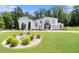 Expansive lawn and meticulous landscaping highlight this grand home's classic architecture at 2425 Wild Oak Ct, Stockbridge, GA 30281