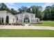 Luxury home with immaculate lawn, mature trees, and well-manicured bushes offers stunning curb appeal at 2425 Wild Oak Ct, Stockbridge, GA 30281