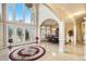 Grand foyer with high ceilings, marble floors, and an elegant view of the dining room at 2425 Wild Oak Ct, Stockbridge, GA 30281
