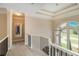 Elegant hallway with a view to the foyer through an arched window at 2425 Wild Oak Ct, Stockbridge, GA 30281