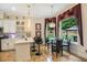 Bright kitchen featuring a breakfast bar, wine rack, stainless appliances, and a dining area with backyard views at 2425 Wild Oak Ct, Stockbridge, GA 30281