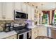 Spacious kitchen boasts stainless appliances, ample cabinet space, a tile backsplash, and an adjacent dining area at 2425 Wild Oak Ct, Stockbridge, GA 30281